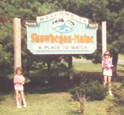  Our daughters posing in front of a town sign